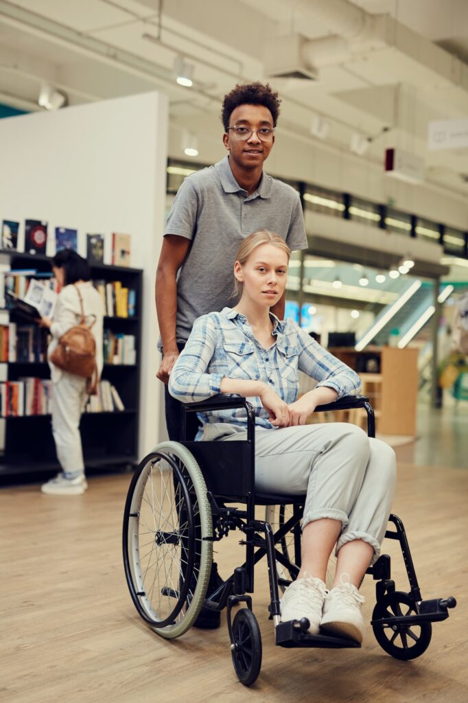 Black student pushing wheelchair with girl